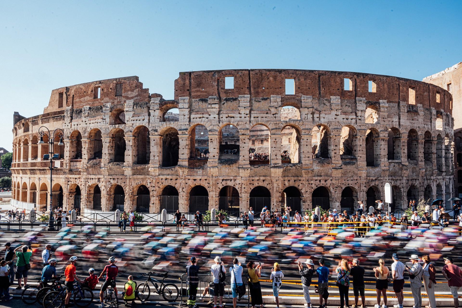 Cyclists of the Giro d’Italia peloton ride past the Colosseum in Rome during Stage 21