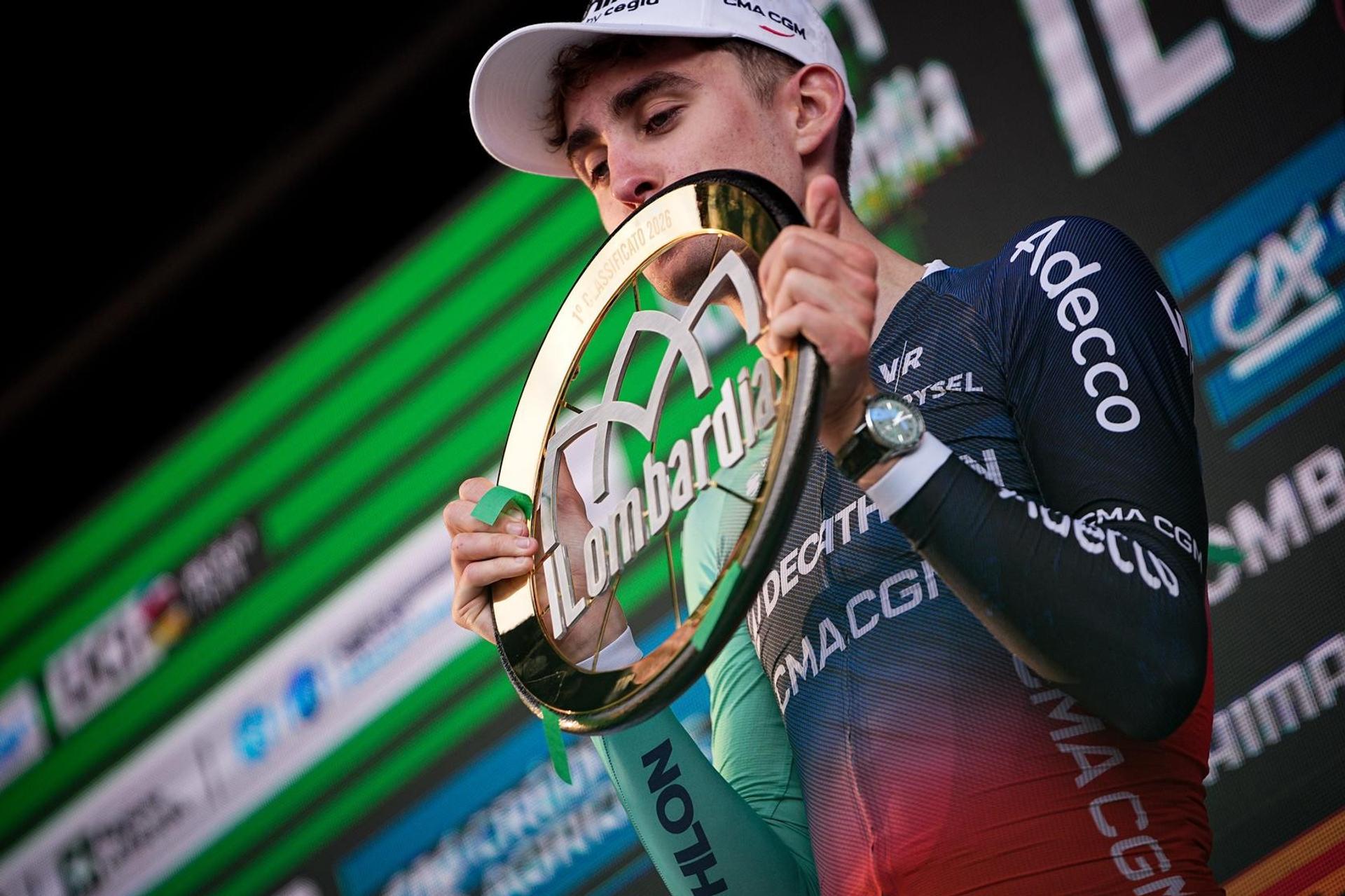 Paul Seixas holds the Il Lombardia trophy after his victory.