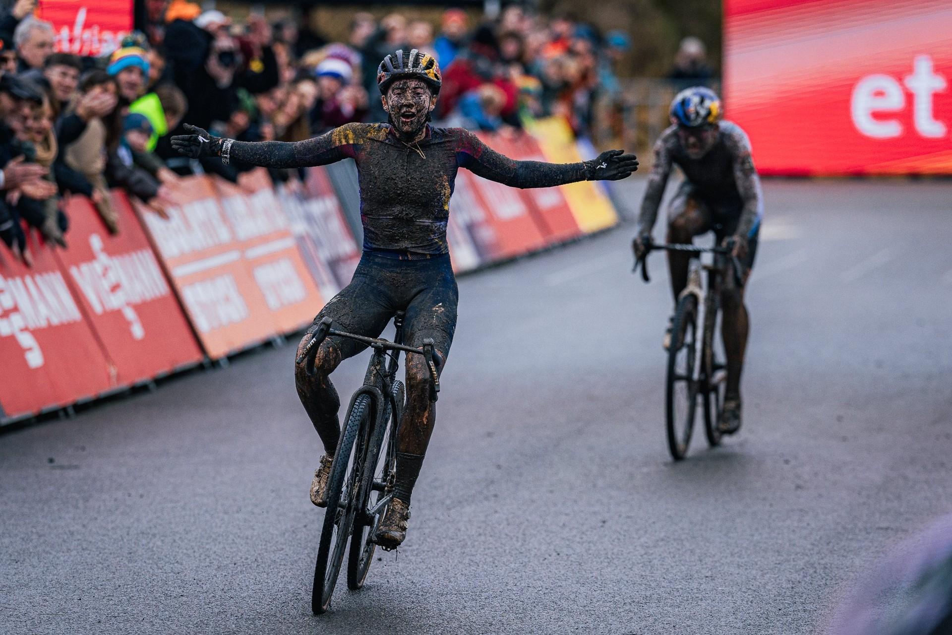 Blanka Vas rides with her arms outstretched as another cyclist follows behind.