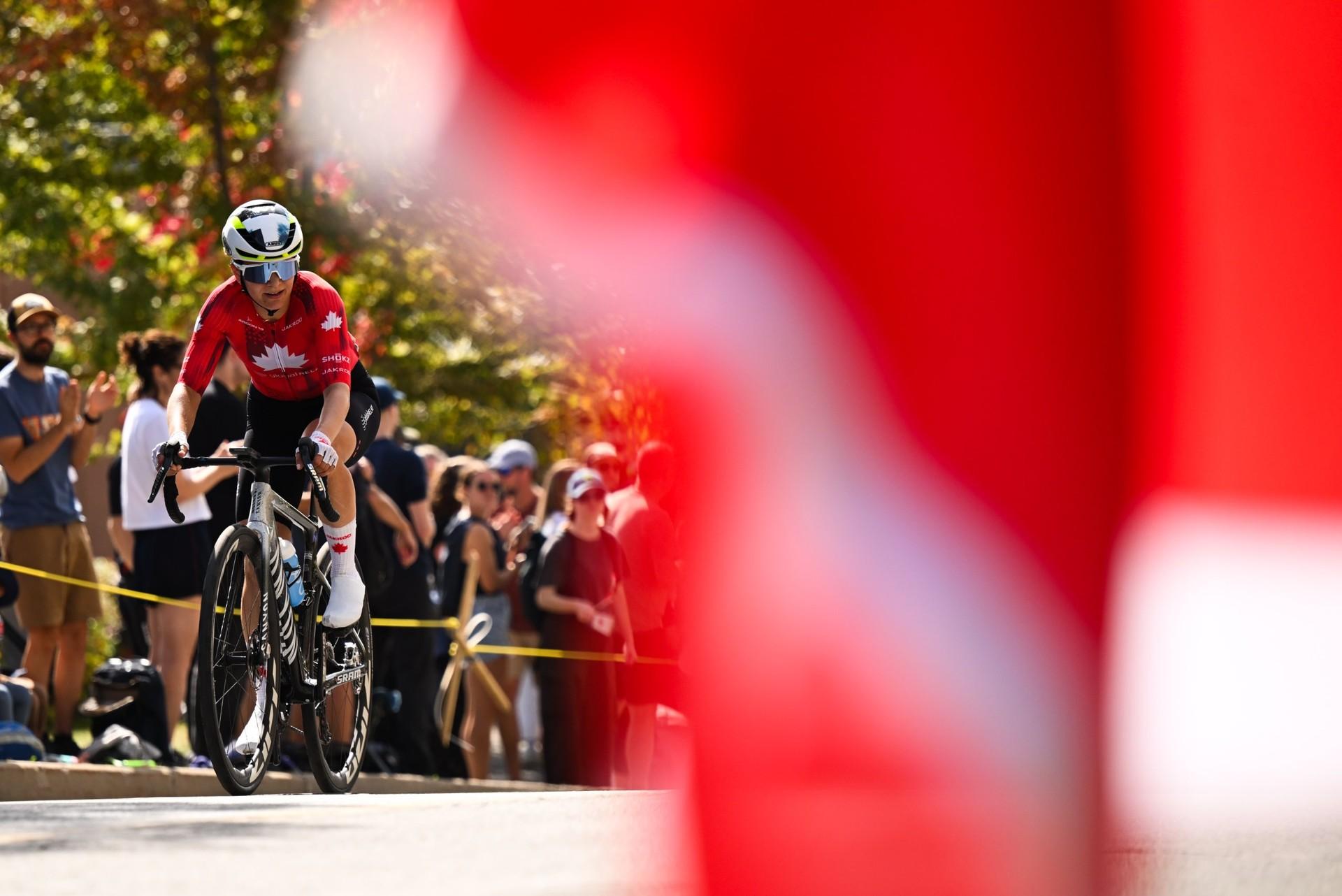 Olivia Baril rides her bike past spectators during the time trial.