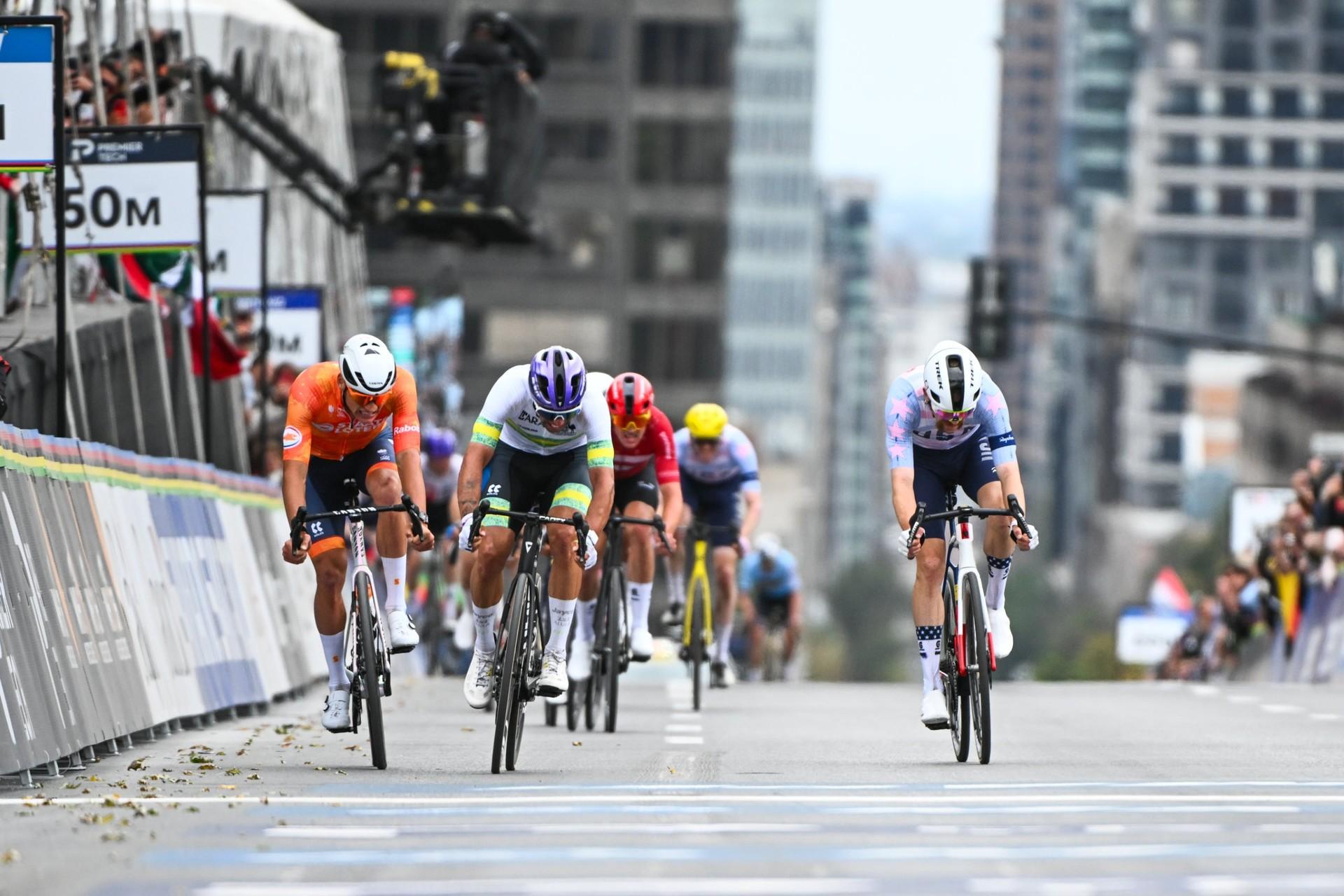 Brandon McNulty leads the sprint toward the finish, with Michael Matthews and other riders close behind.