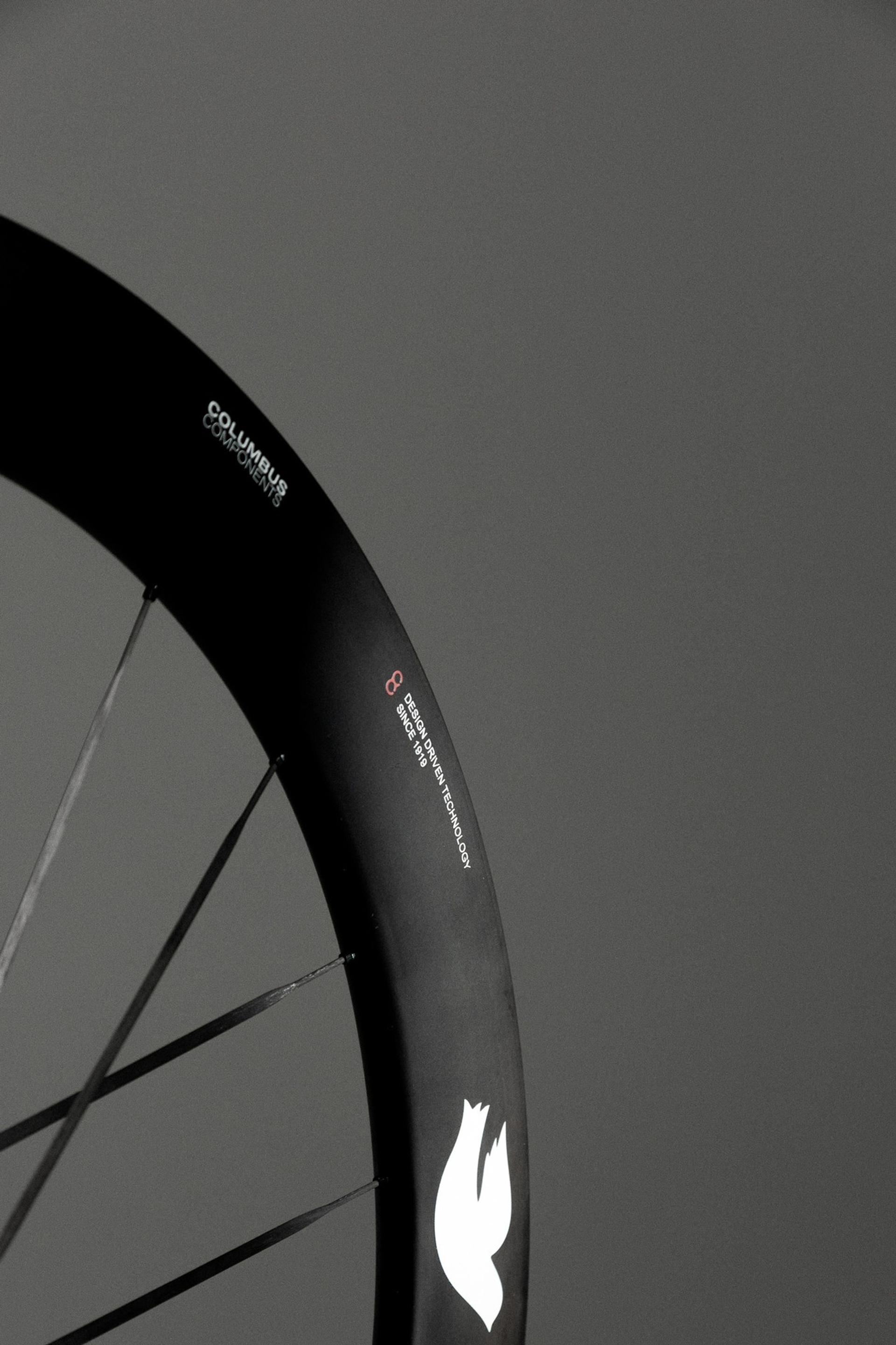 Close-up of the Columbus Cento 62 carbon wheel’s deep rim, spokes and white Columbus logo