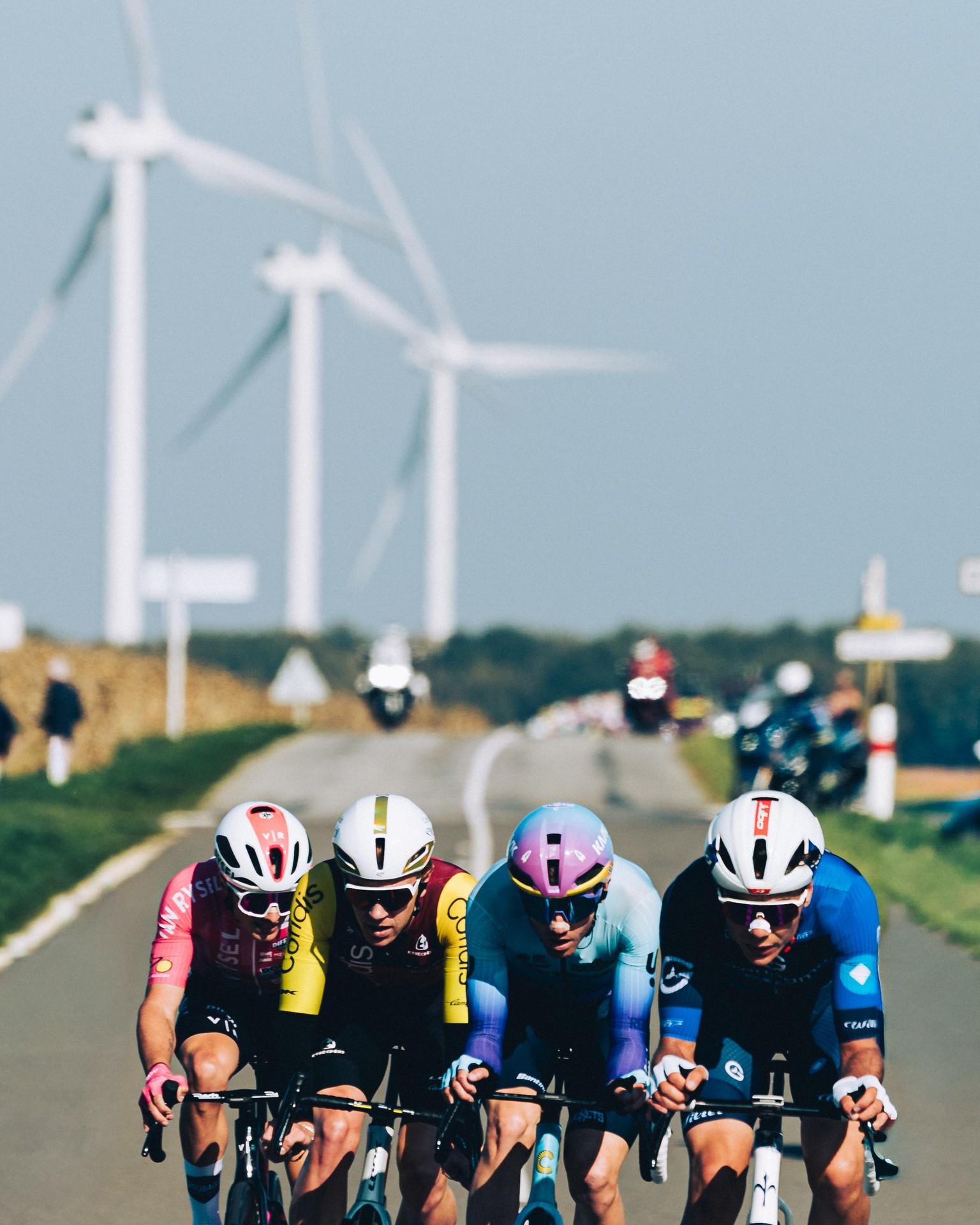 Groupama-FDJ rider in Paris-Tours breakaway with wind turbines backdrop