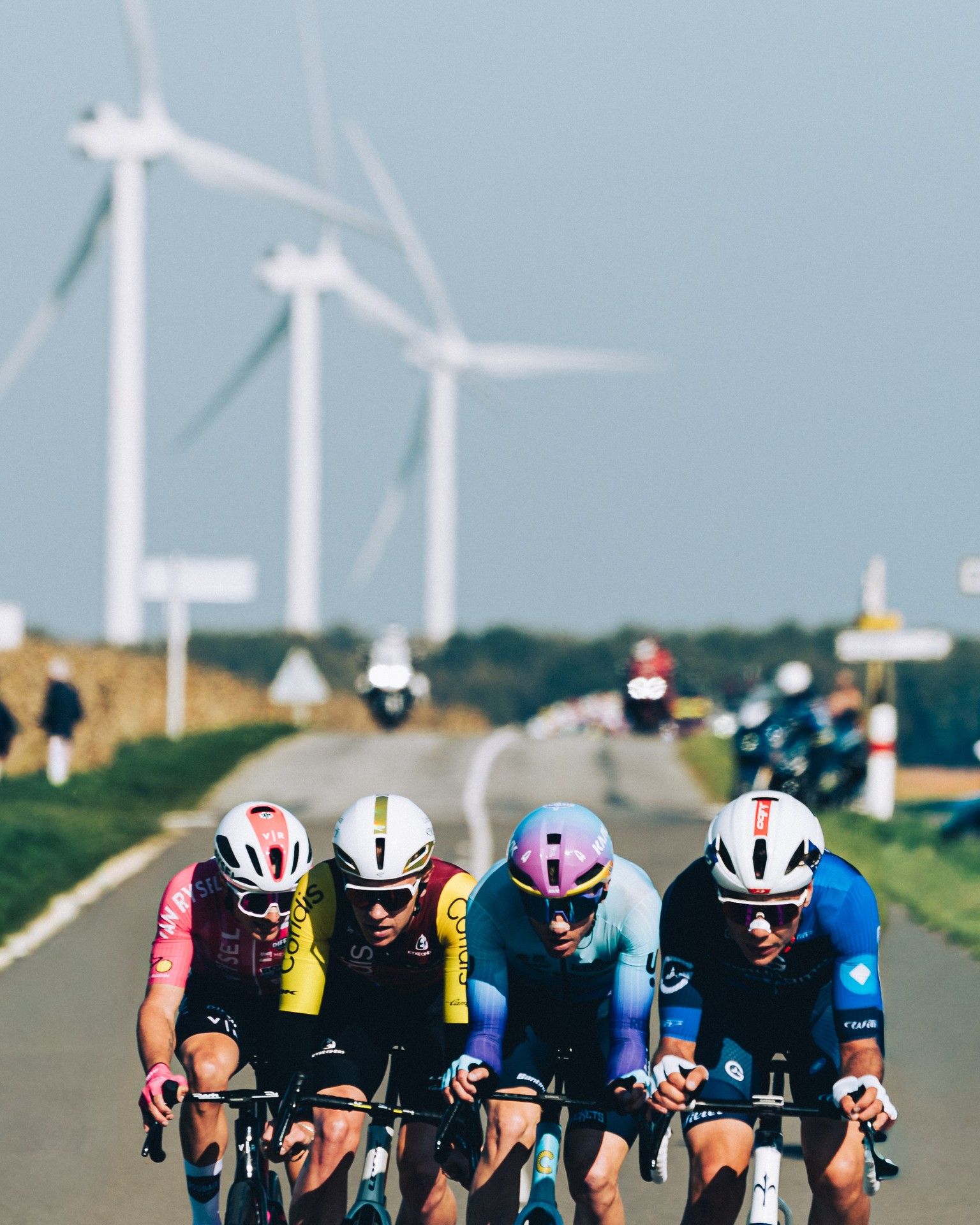 Groupama-FDJ rider in Paris-Tours breakaway with wind turbines backdrop