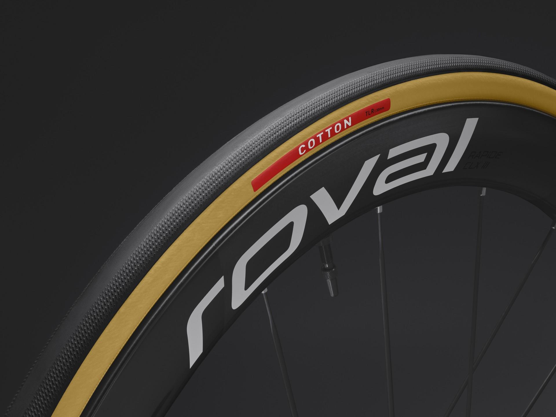 Close-up of a Specialized Turbo Cotton tire on a Roval carbon fiber road bike wheel rim with tan sidewalls.