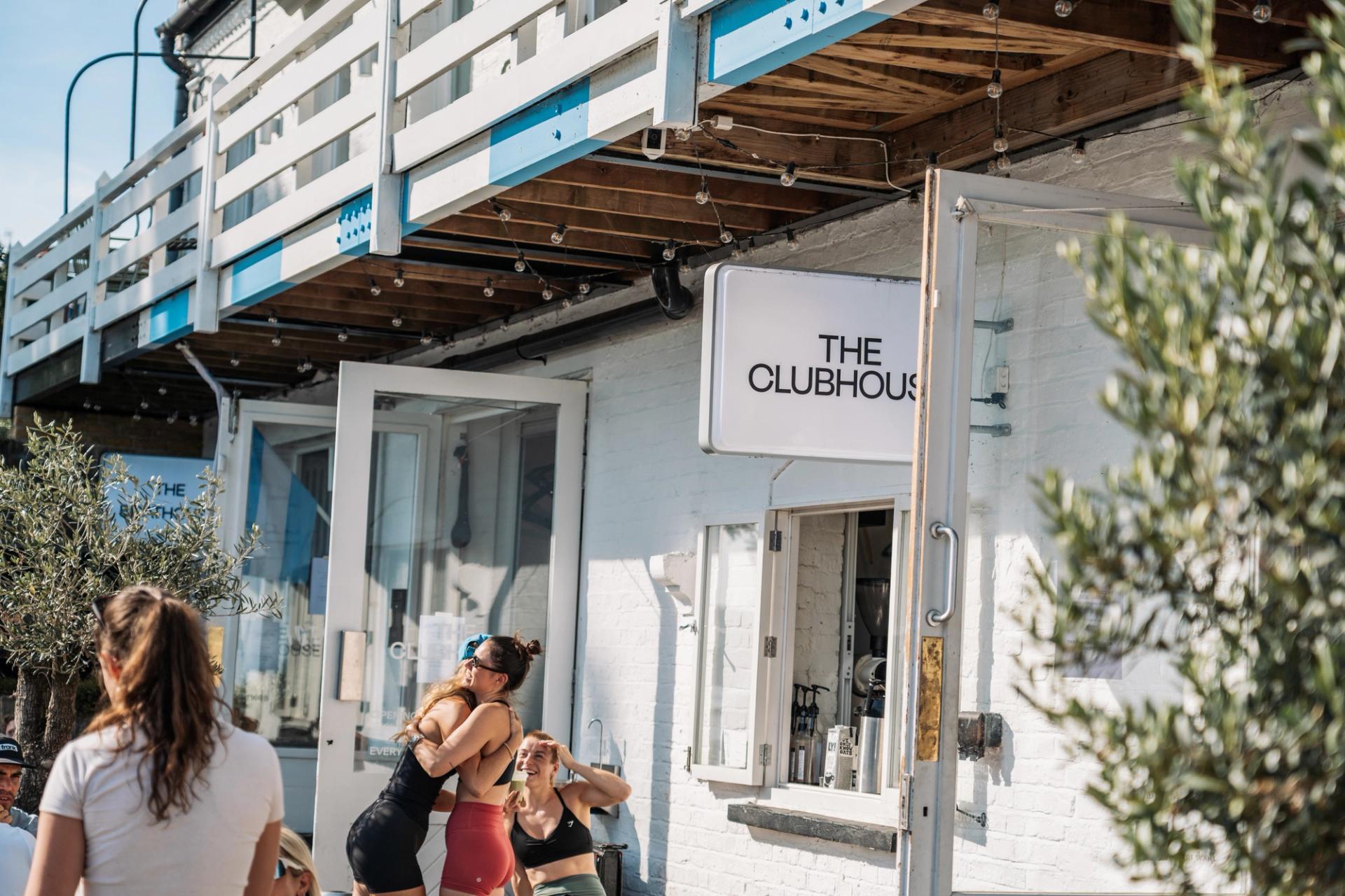 A group of runners standing outside The Clubhouse café
