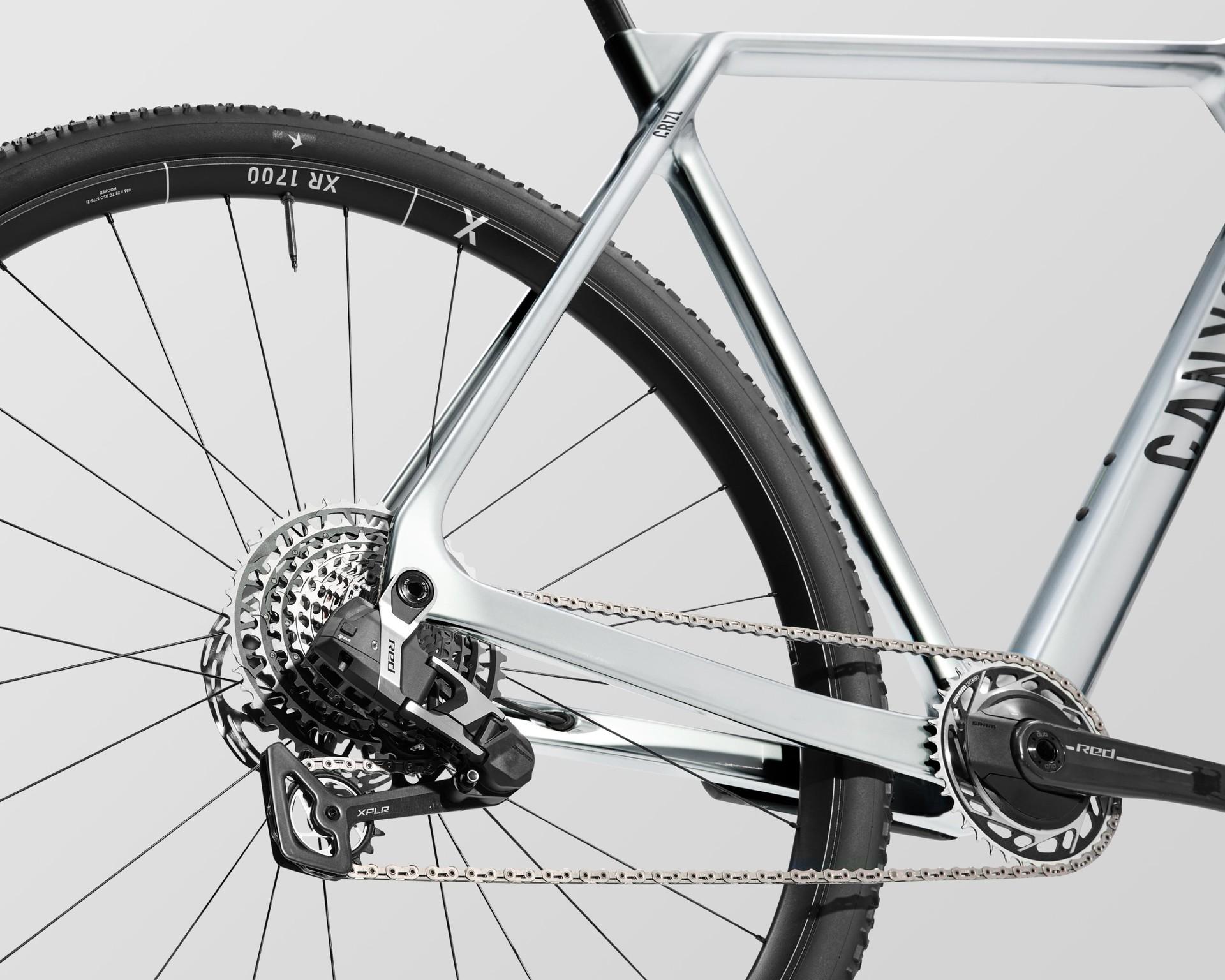 Close-up of the silver Canyon Grizl's rear drivetrain, including cassette, derailleur, chain and large 32-inch wheel