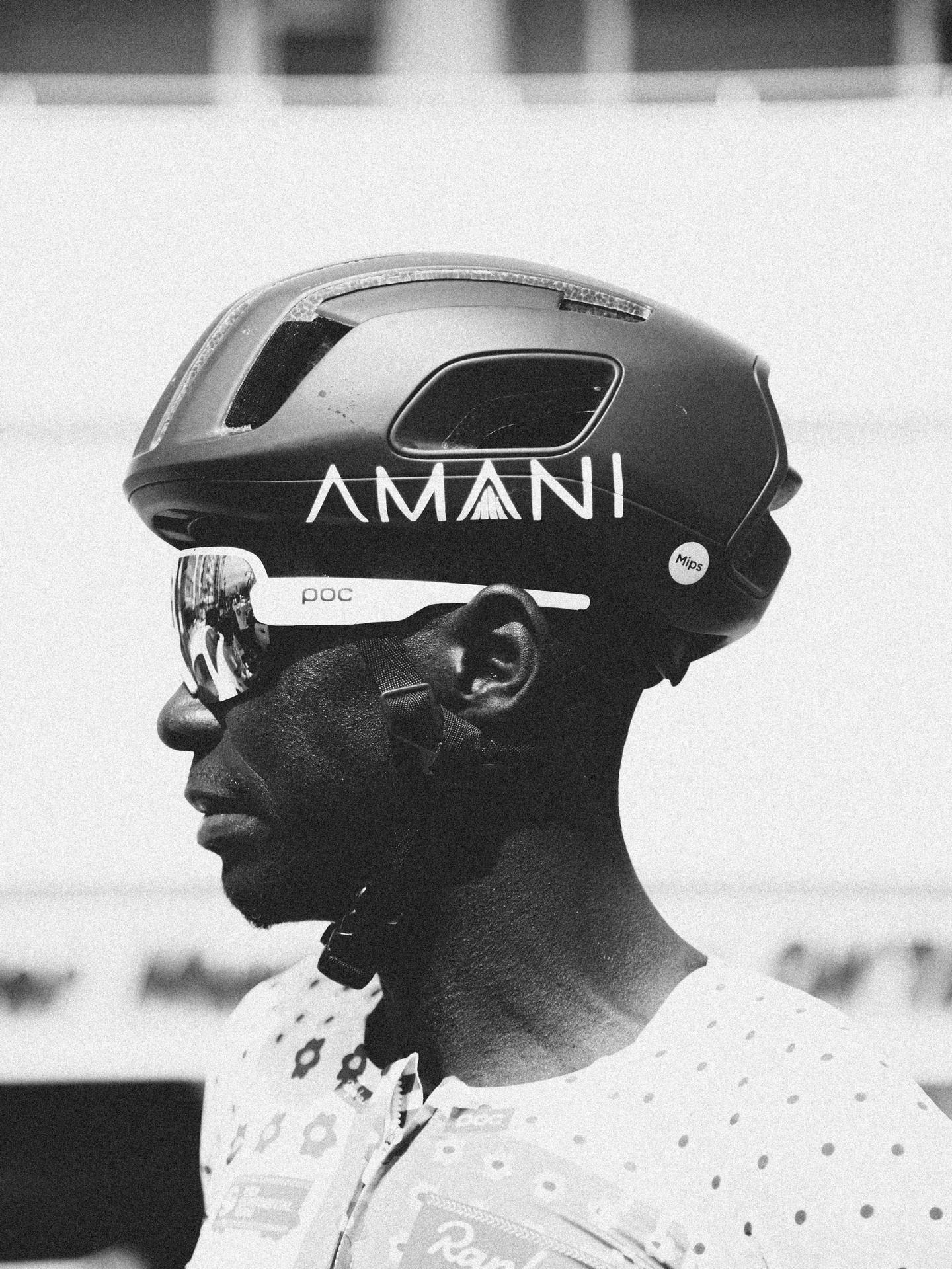 Cyclist wearing AMANI helmet looks to the side during an indoor race event