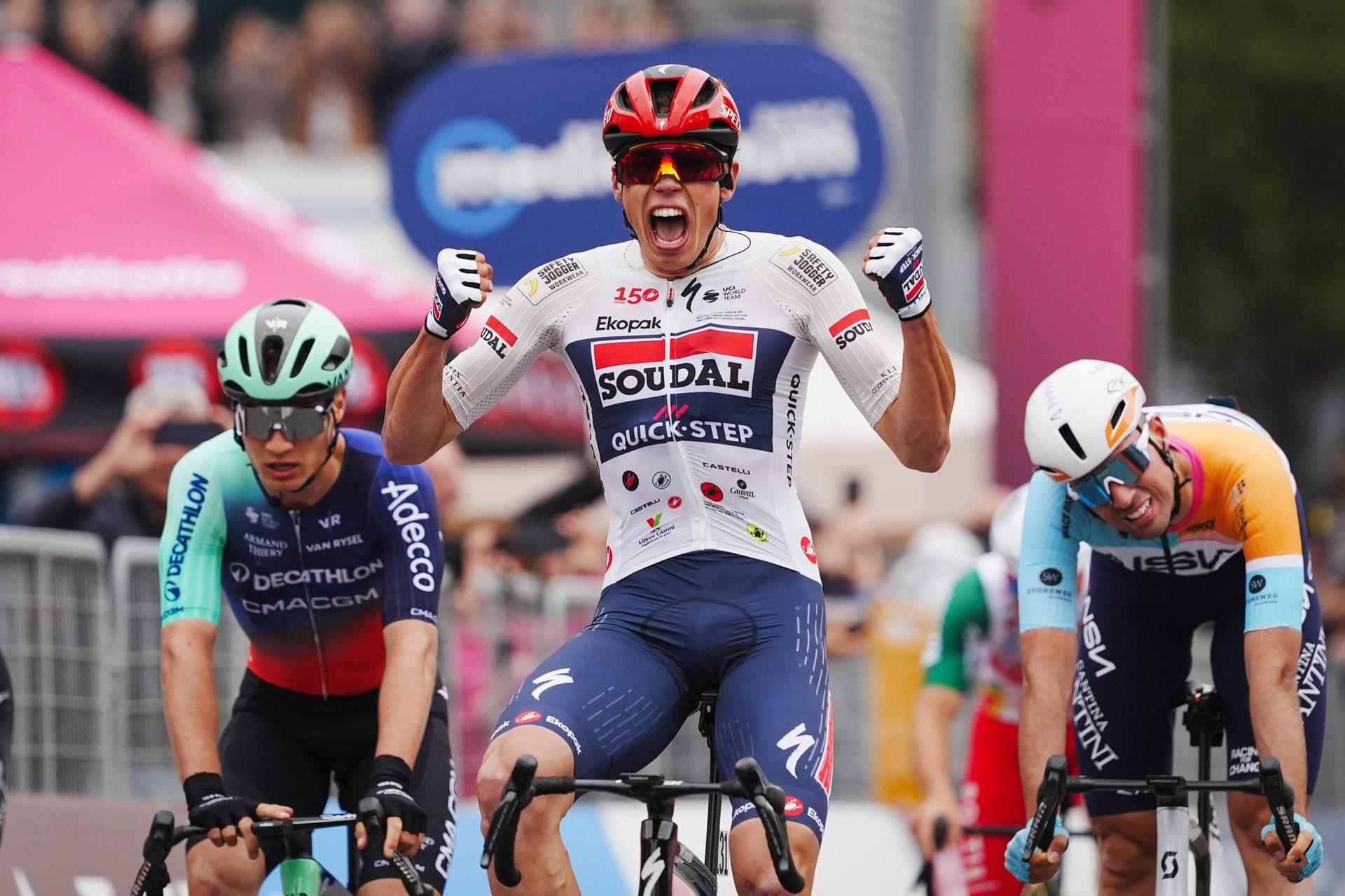 Paul Magnier crosses the finish line on Stage 1 of the Giro d’Italia in Bulgaria, celebrating victory.