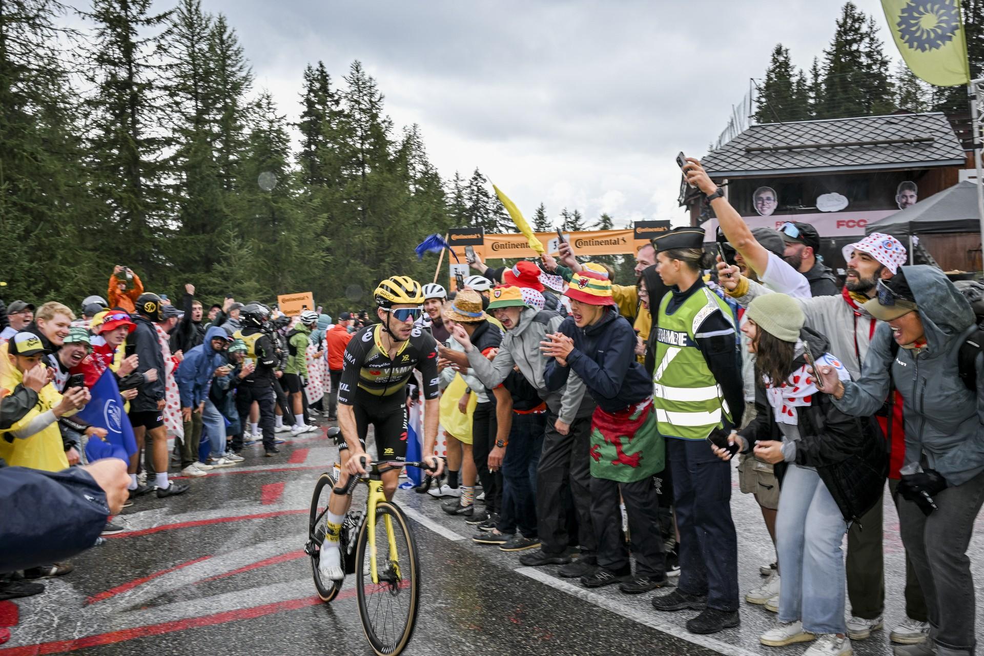 Simon Yates rides past crowds on wet road to La Plagne in Tour de France