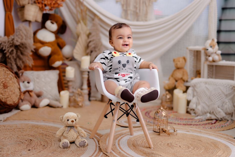 A baby girl wearing a beautiful, festive Eid dress with intricate details.