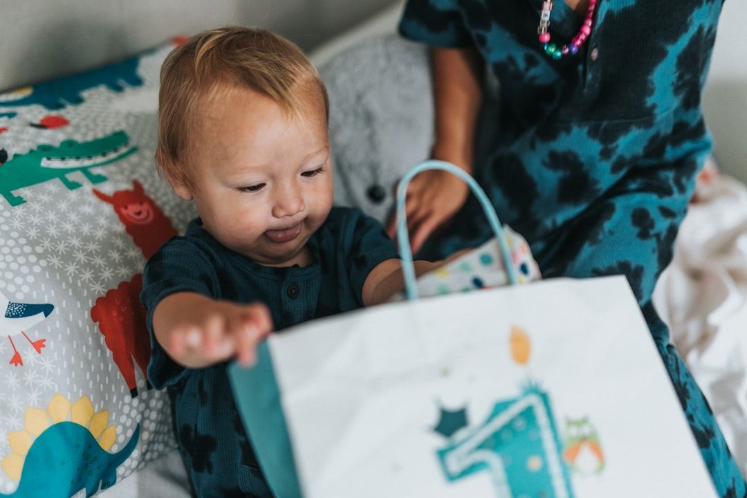 A parent smiling as they hold a package of baby clothes, illustrating the satisfaction of receiving a quick delivery.