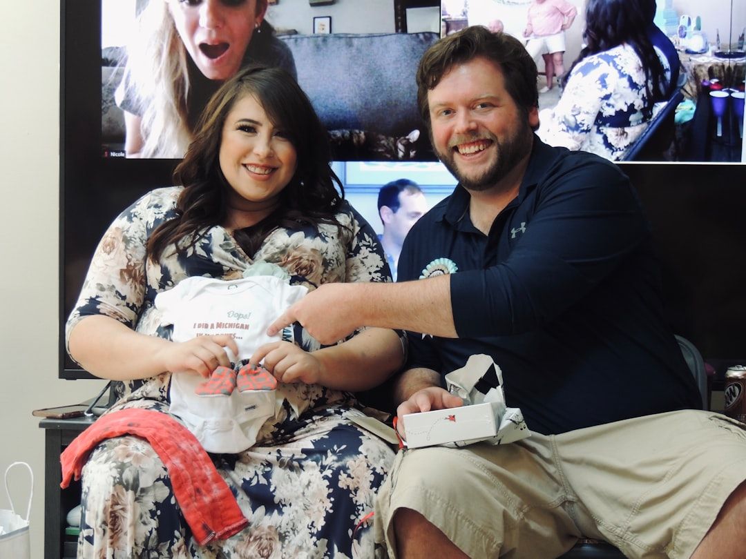 A parent happily receiving a package containing baby clothes, signifying quick delivery.