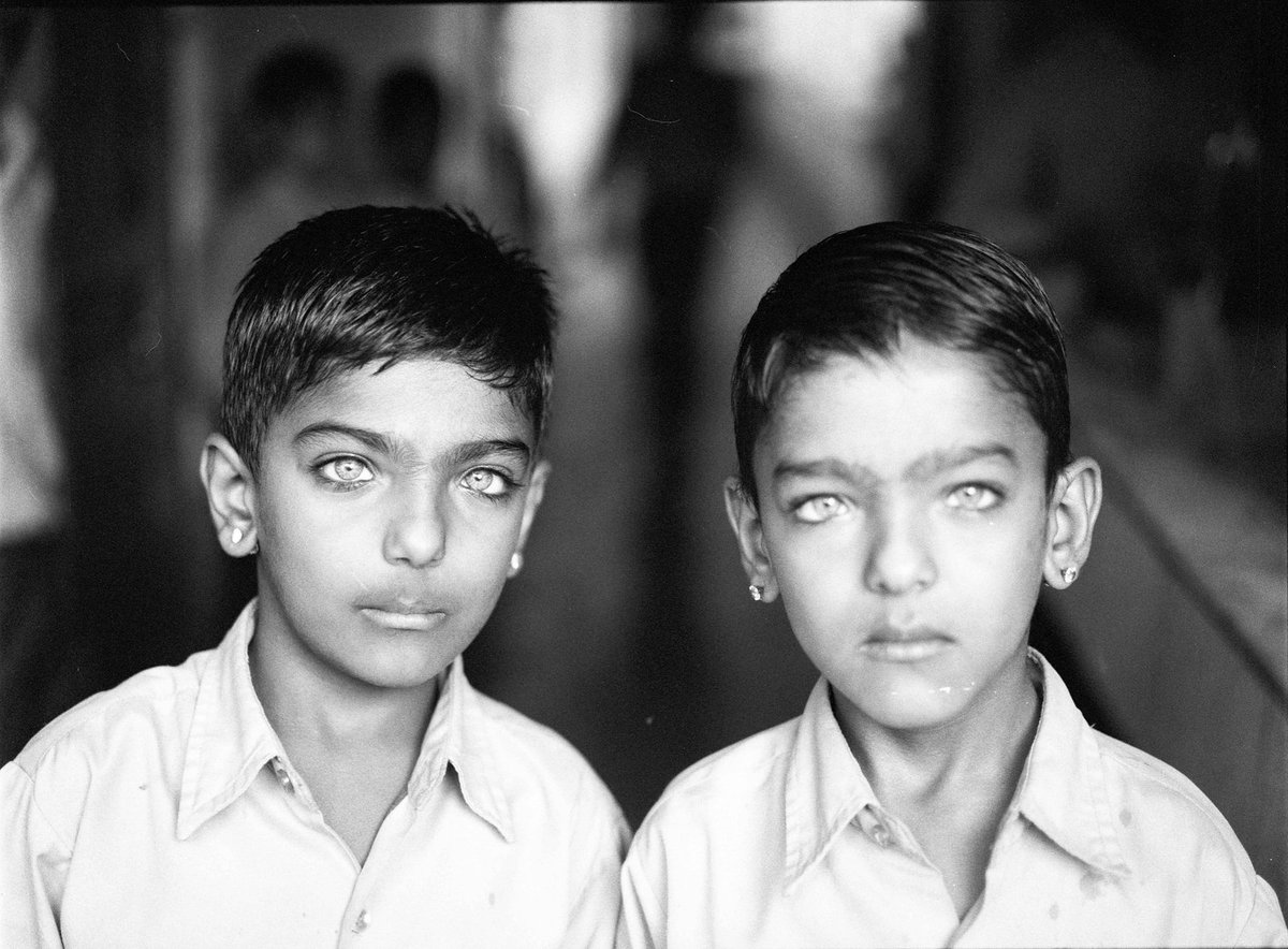 Black and white photograph of two boys standing side by side