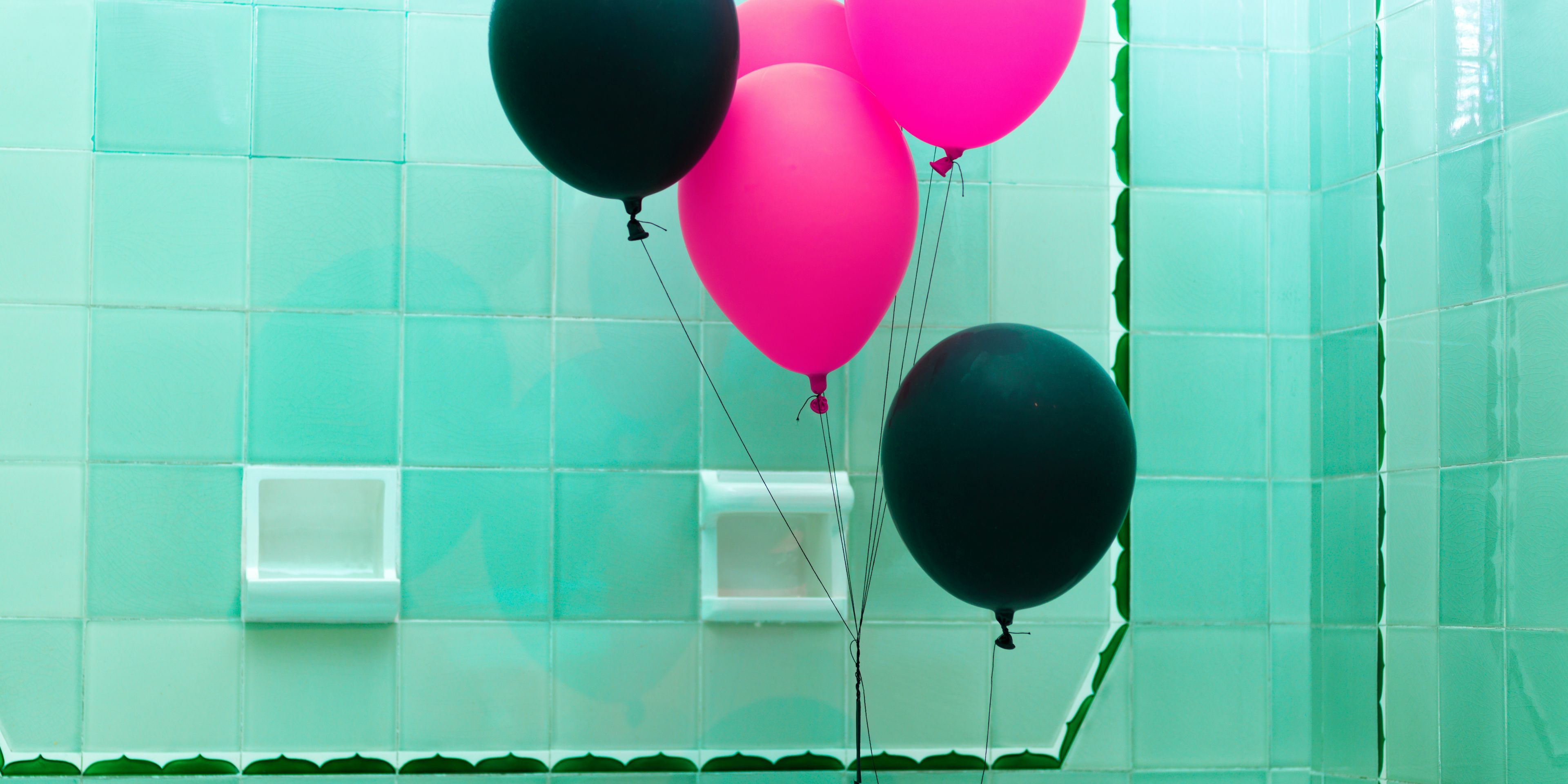 woman in bathtub with balloons