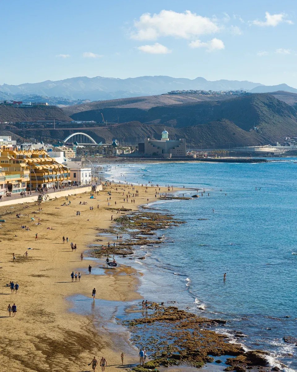 Aerial view of Playa de Las Canteras with golden sand, the Atlantic Ocean, and the Las Palmas promenade