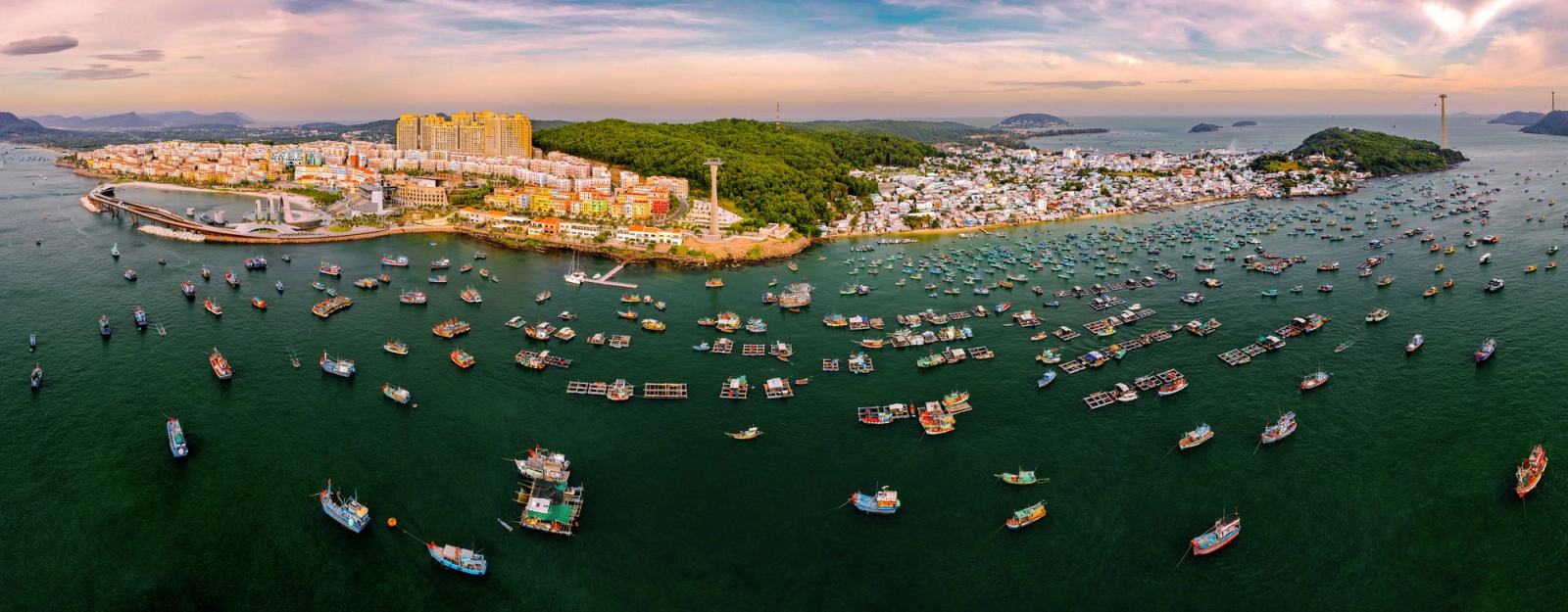 Wide aerial panorama of the harbour, boats and Sunset Town coastline.