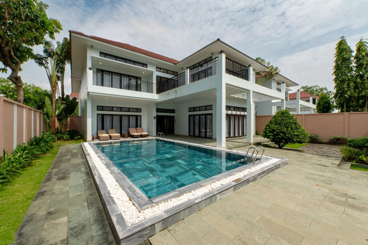 A two-storey villa overlooking a private swimming pool.