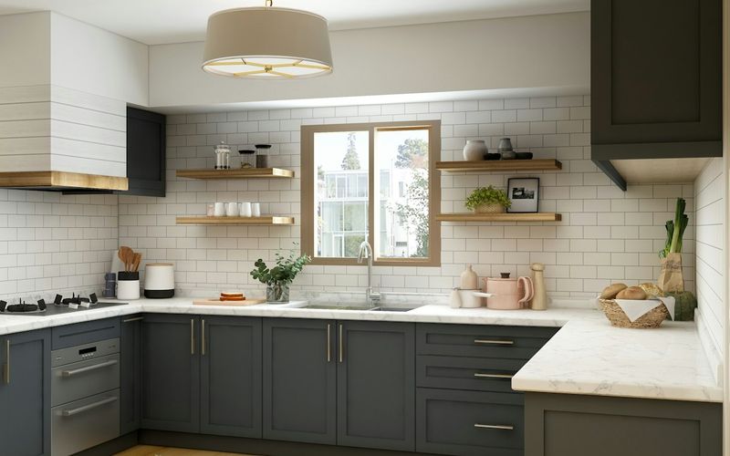A renovated kitchen with dark cabinetry and a large island
