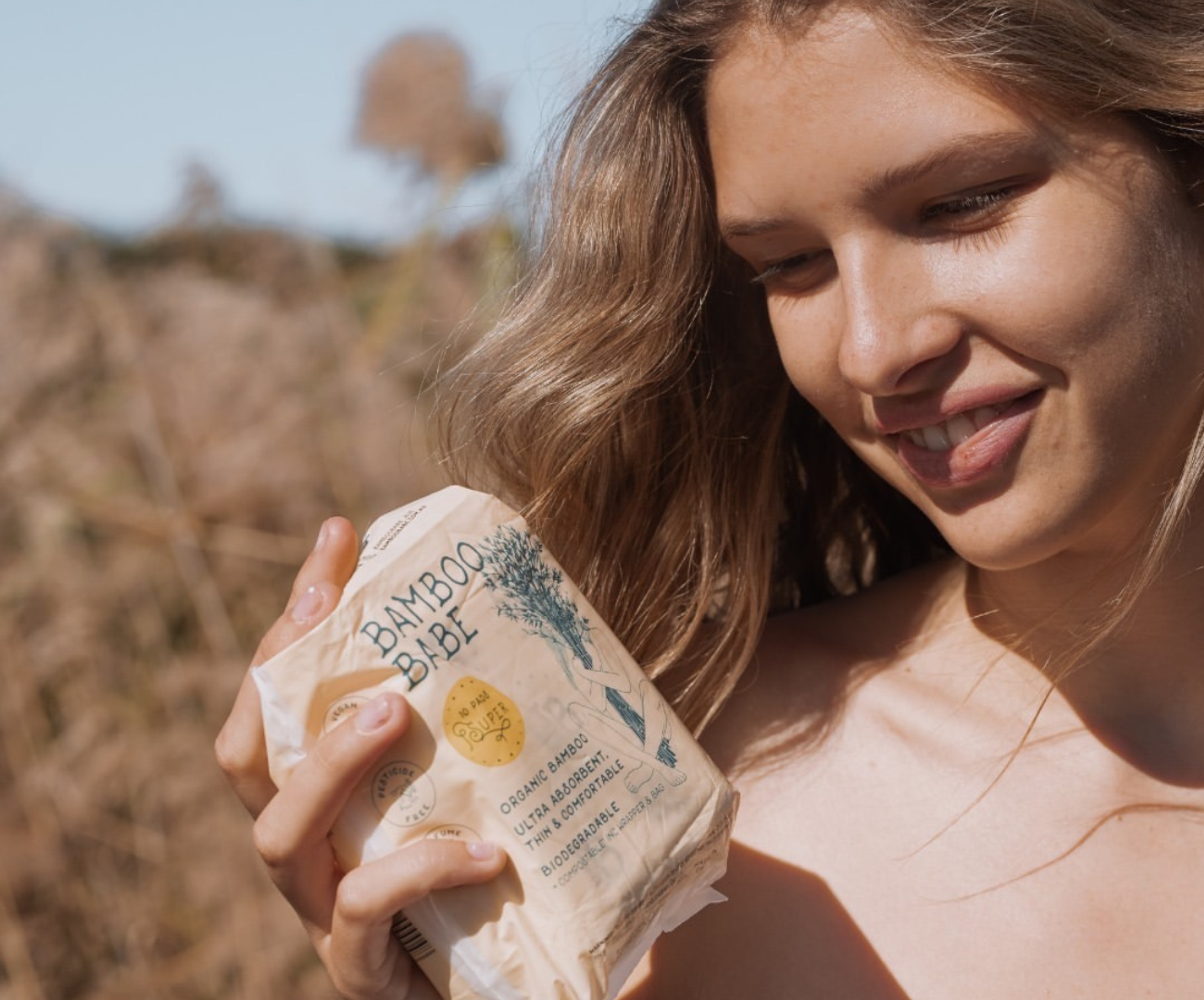 woman holding bamboo babe compostable pads