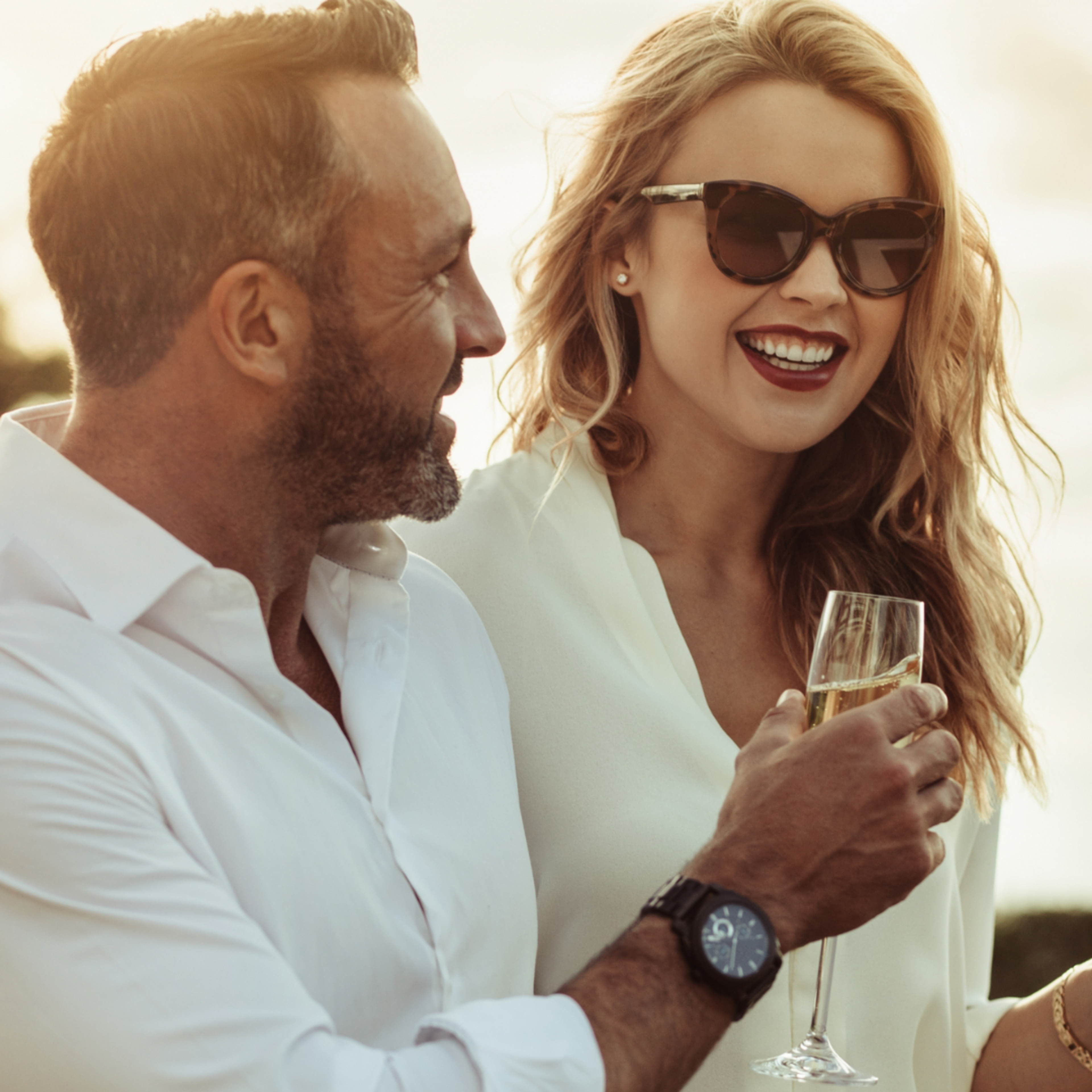 couple enjoying sunset with wine in hand, featuring ethically better products