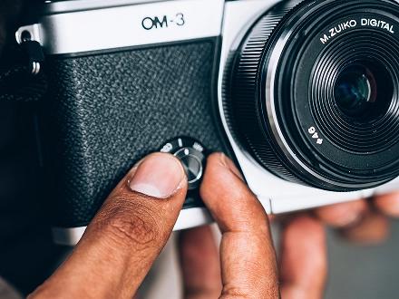 OM SYSTEM OM-3 creative dial on the front of the camera body.