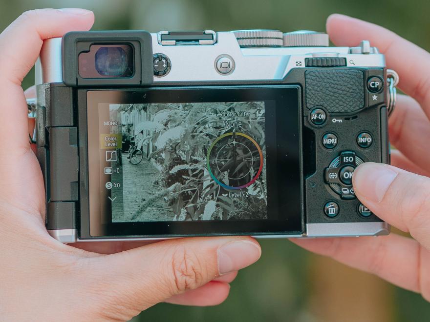 Camera in hands with creative profiles on the back LCD.