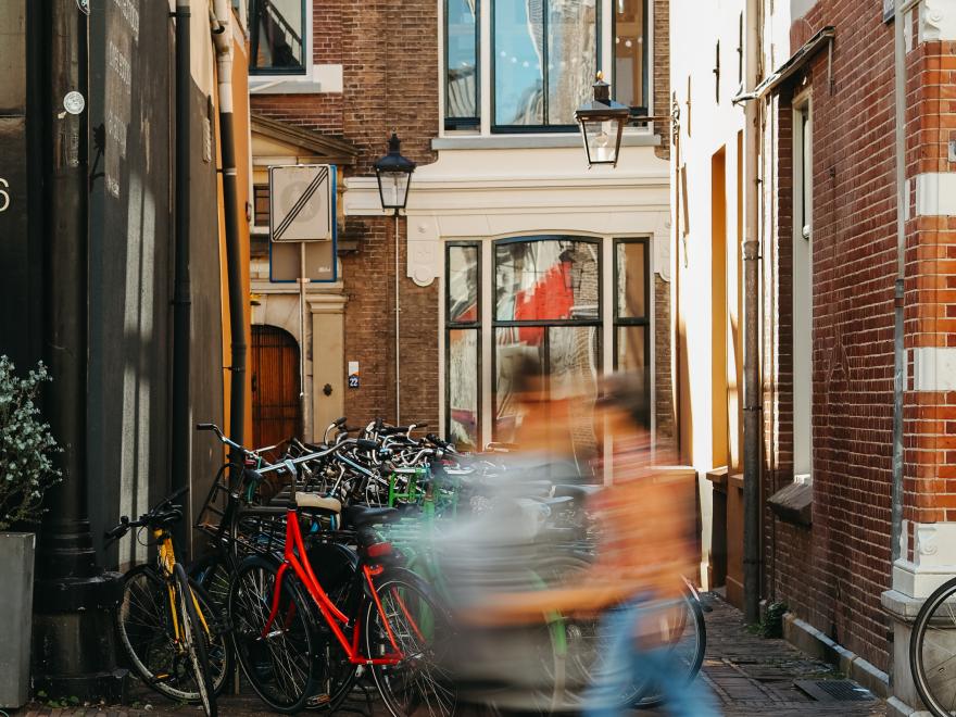 Photo of a city alley with a person in a motion blur photography style.