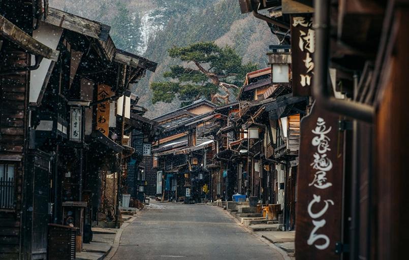 photo taken looking down the street of a town.