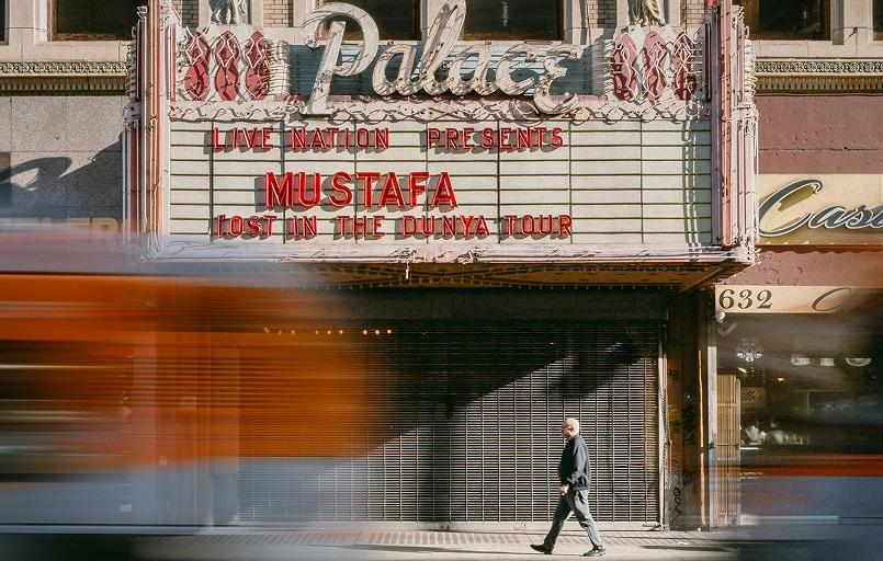 Photo of Mountain in the background slightly off center with green and leave trees in the foreground.