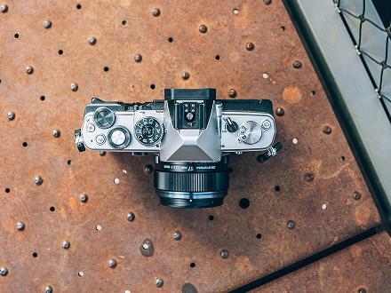 Image of the OM SYSTEM OM-3 showing a close up of the camera dials.