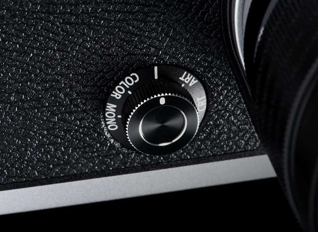 OM SYSTEM OM-3 creative dial on the front of the camera body.