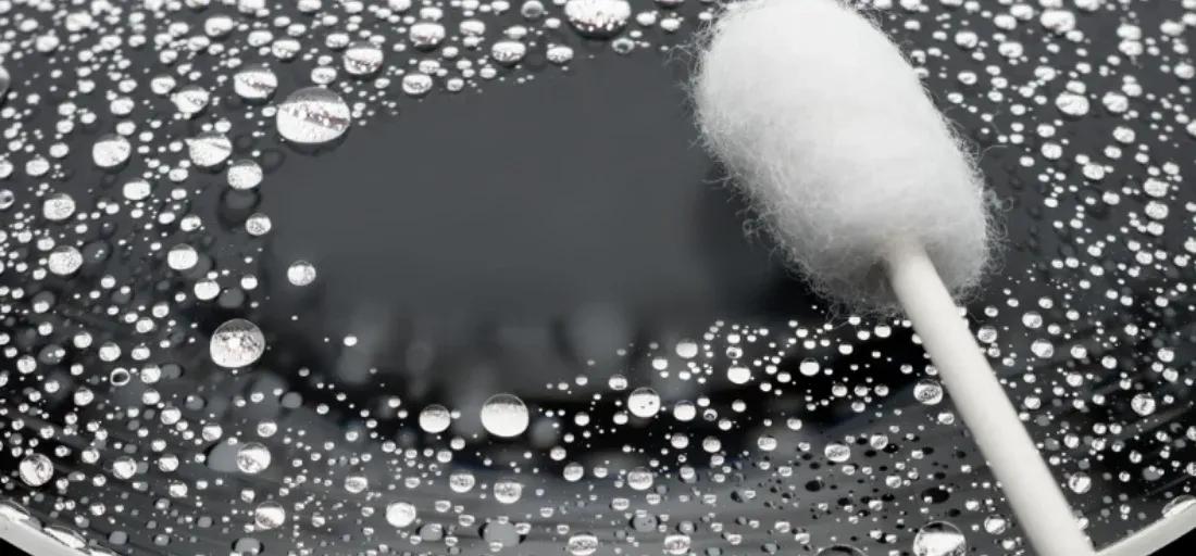 Photo on the lens glass showing how water beads up on the glass making it easy to clean with in the field.
