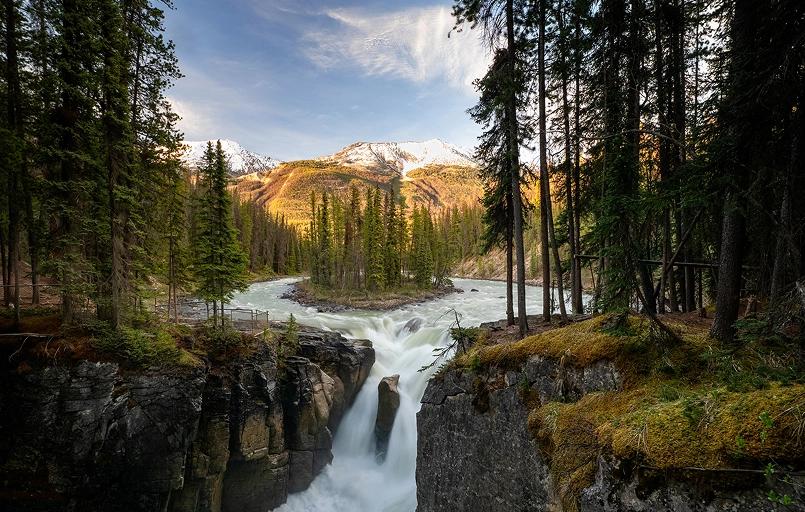 River flows around and island in the middle then shortly failing into a waterfall.