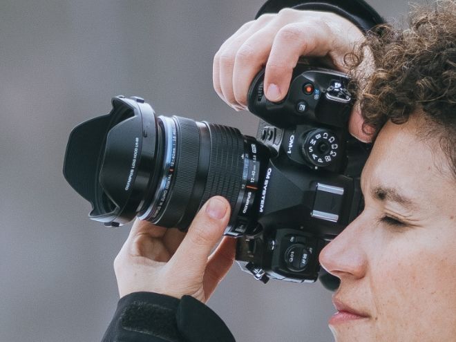 Person holding an OM SYSTEM OM-1 Mark II