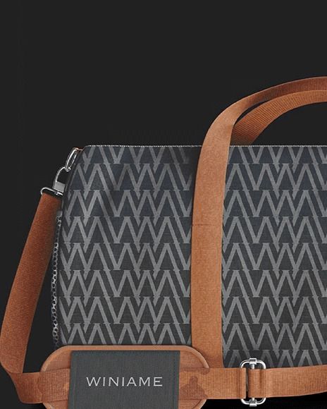 Patterned duffle bag with a tan strap and Winiame tag