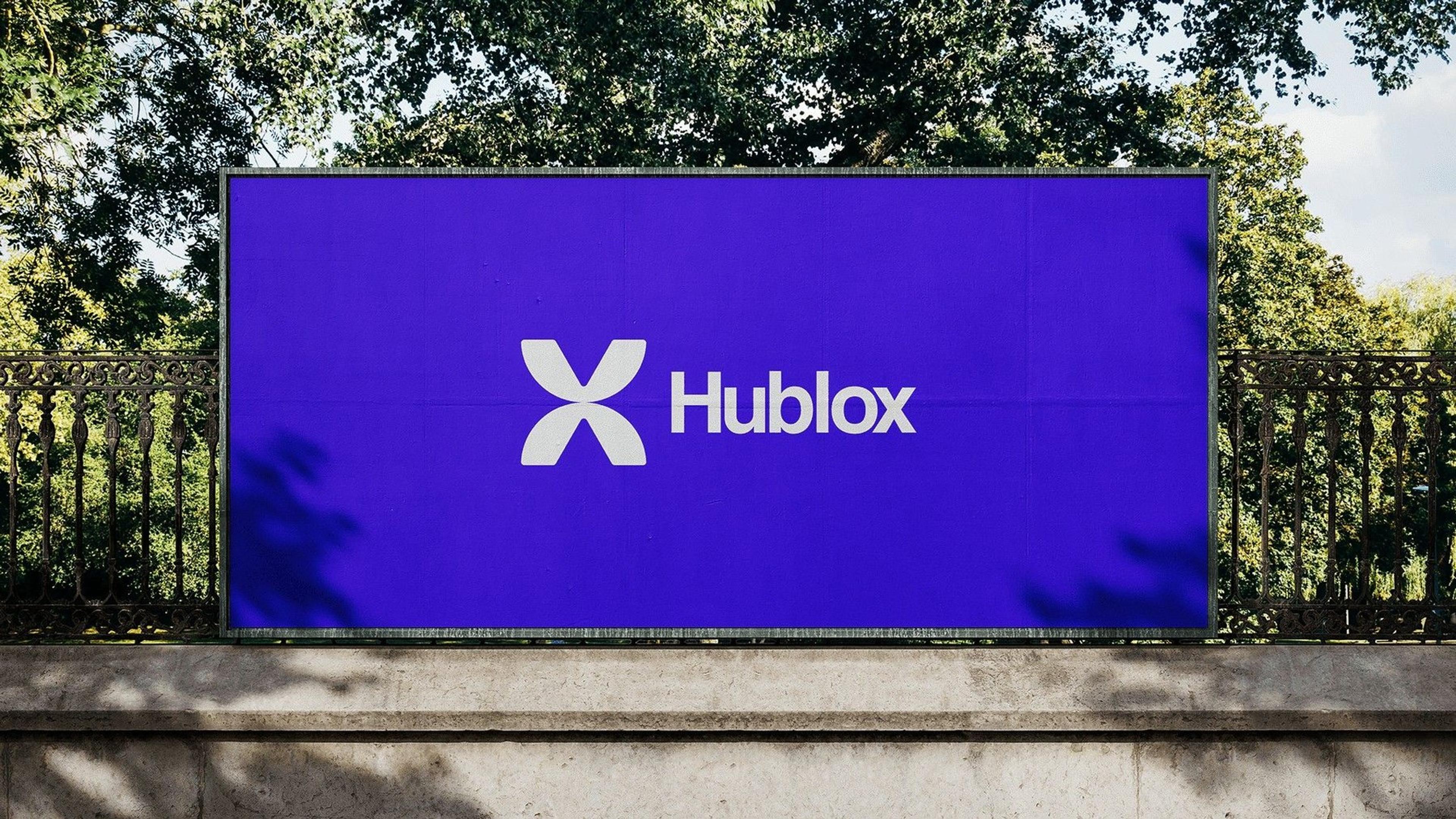 Hublox on a violet billboard, the team in Hublox shirts, the 3D X mark and social posts