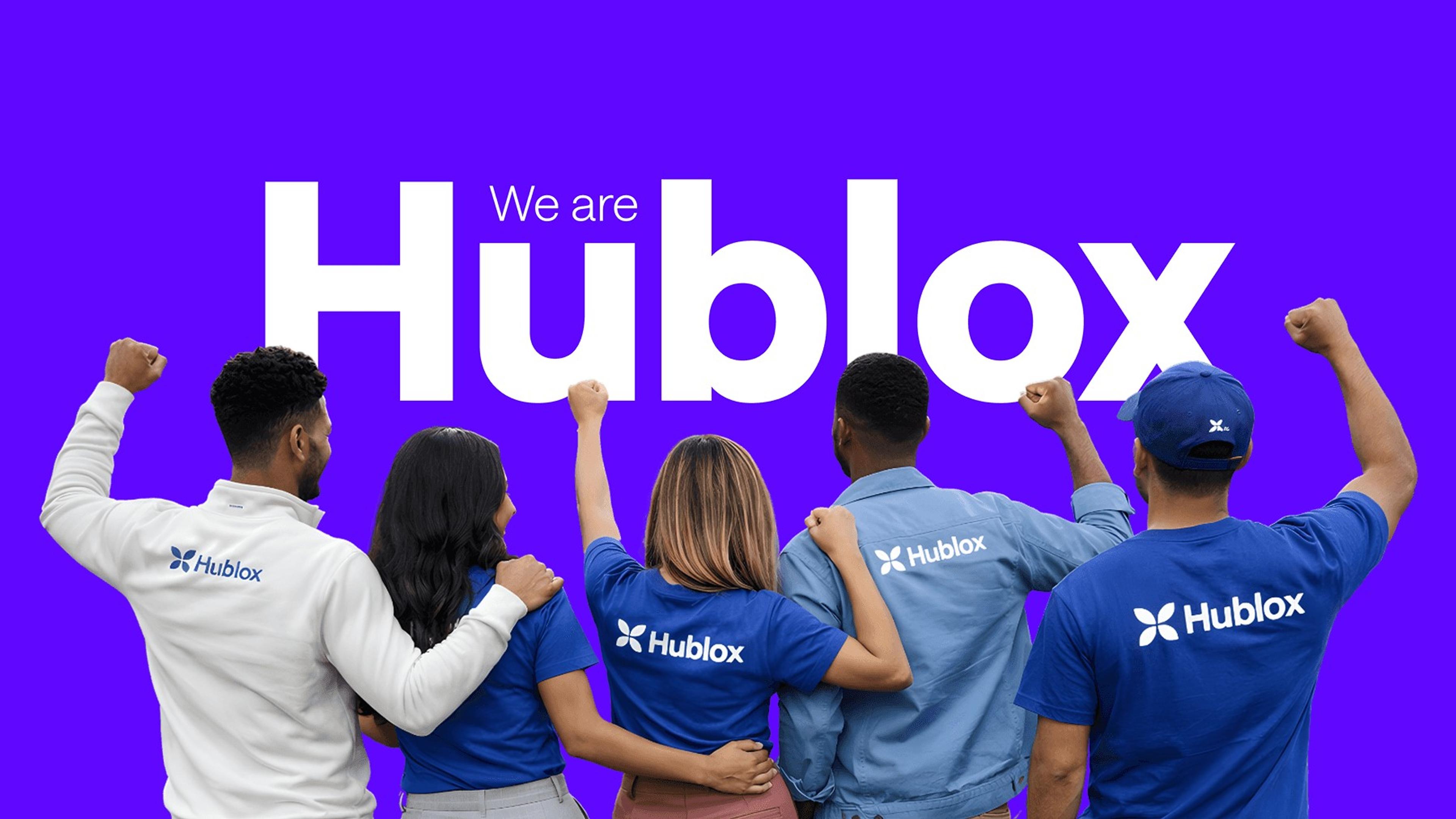 A team in Hublox t-shirts cheering under the line We are Hublox