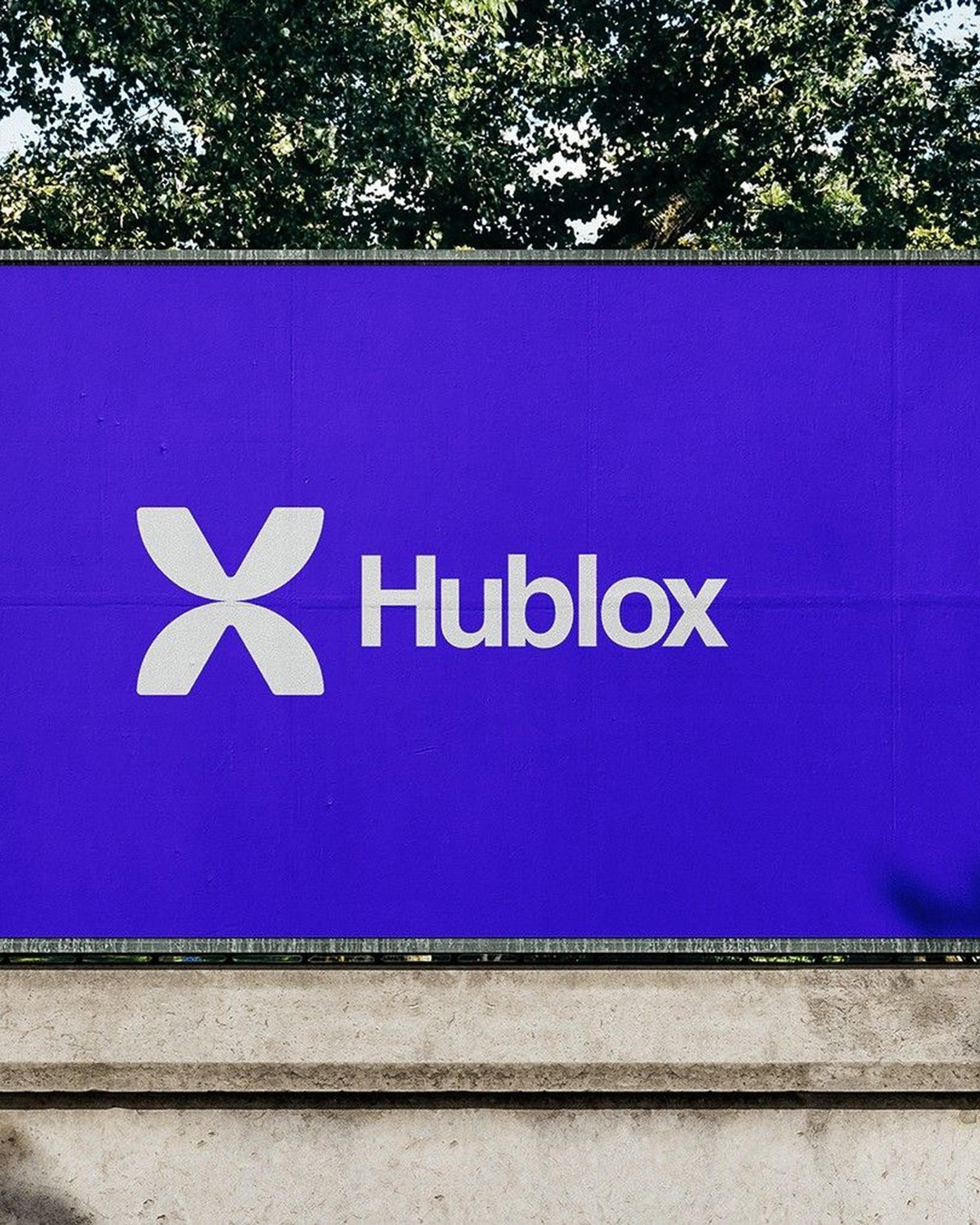 Hublox on a violet billboard, the team in Hublox shirts, the 3D X mark and social posts