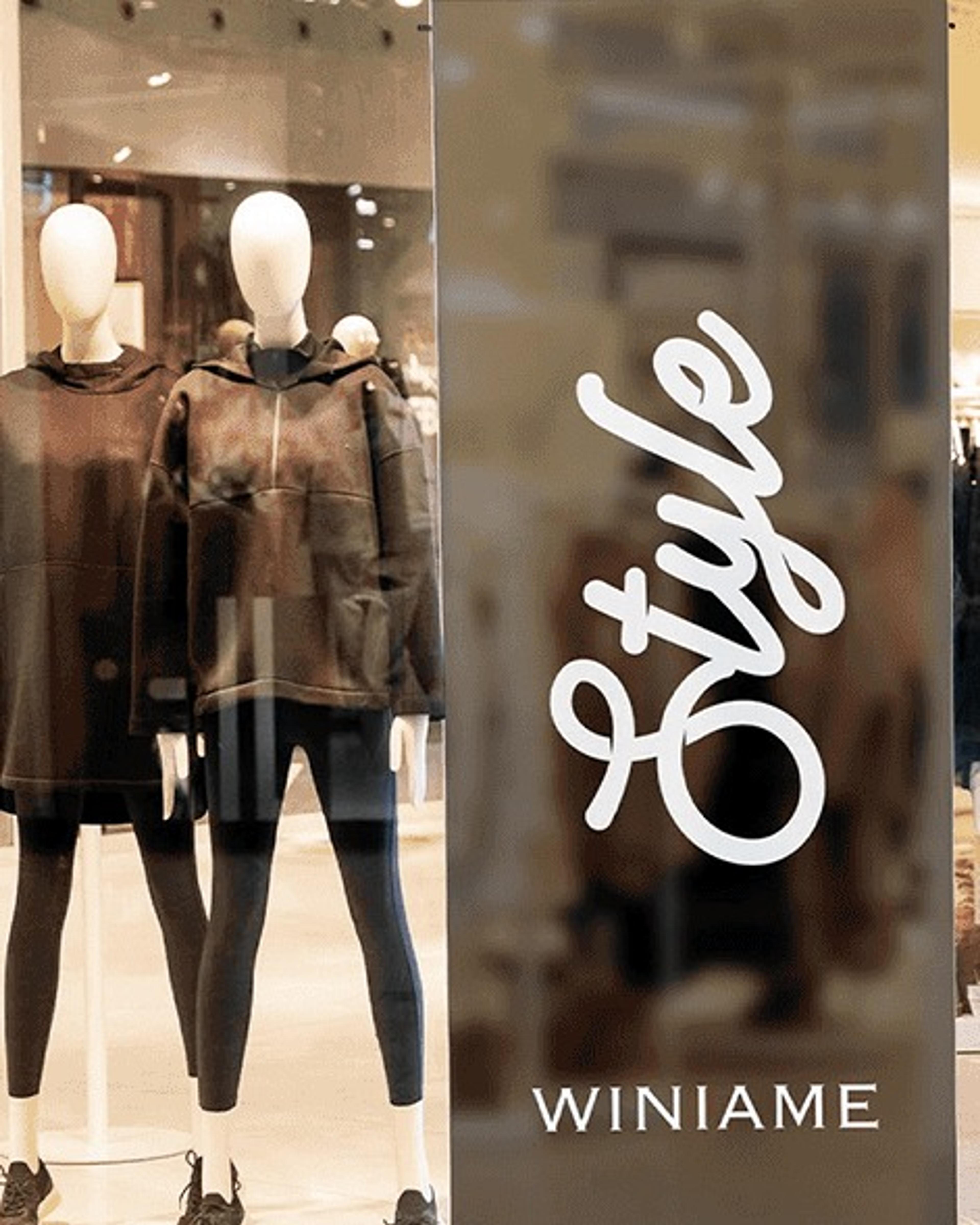 Shop window with mannequins and a Style banner