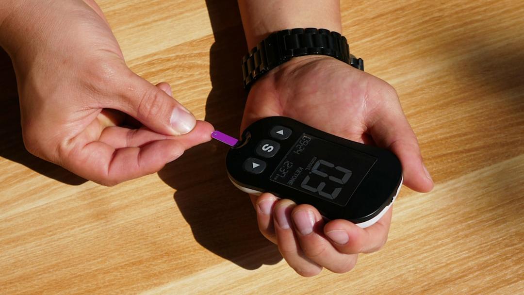 a person holding a thermometer in their hand - Photo by isens usa on Unsplash