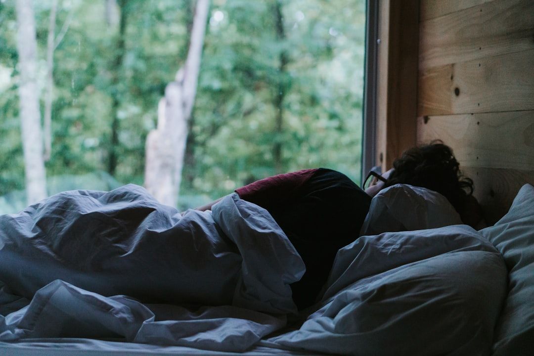 person lying on bed covered with blanket - Photo by Tatiana Rodriguez on Unsplash