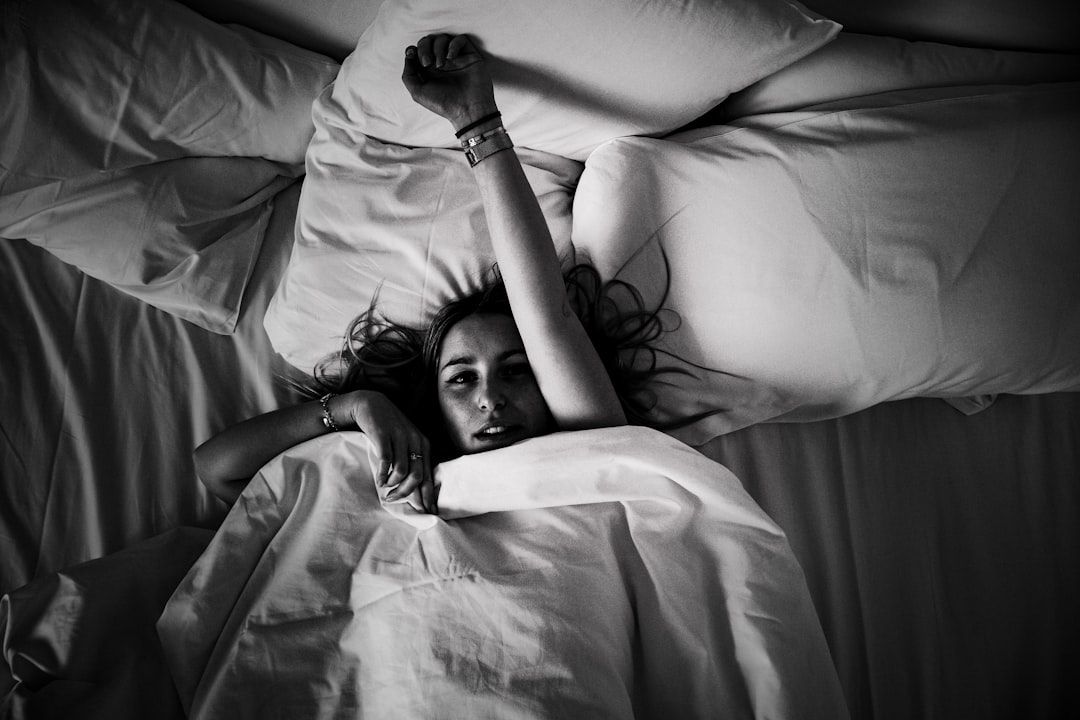 woman laying on bed - Photo by Valentin Lacoste on Unsplash