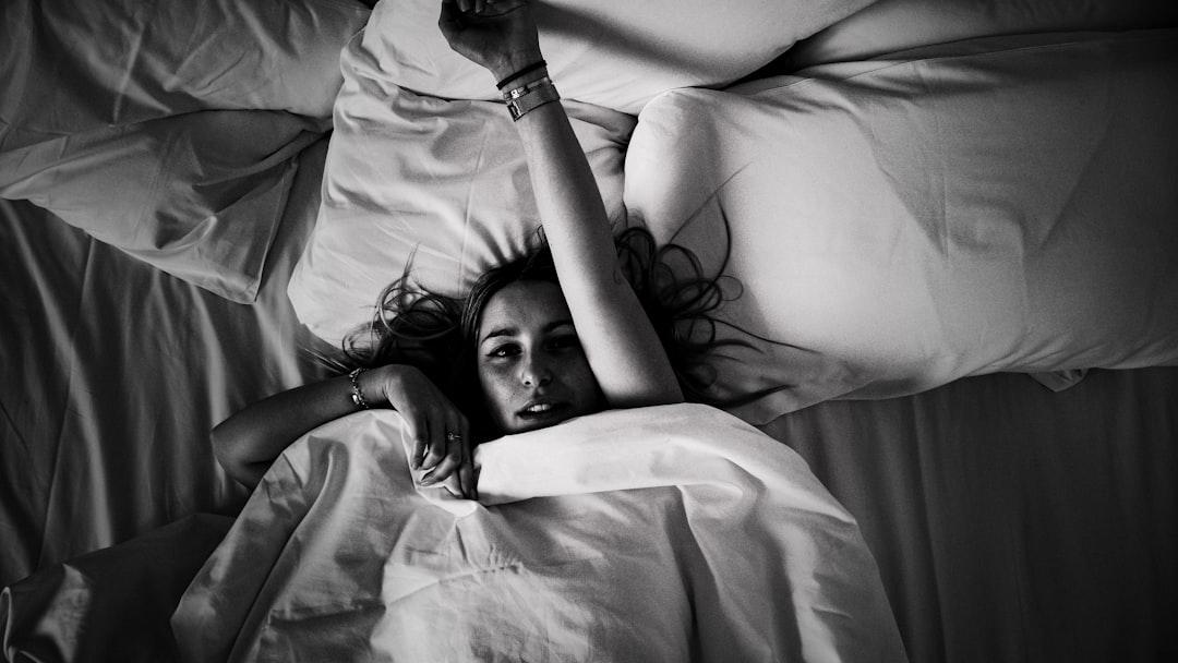 woman laying on bed - Photo by Valentin Lacoste on Unsplash