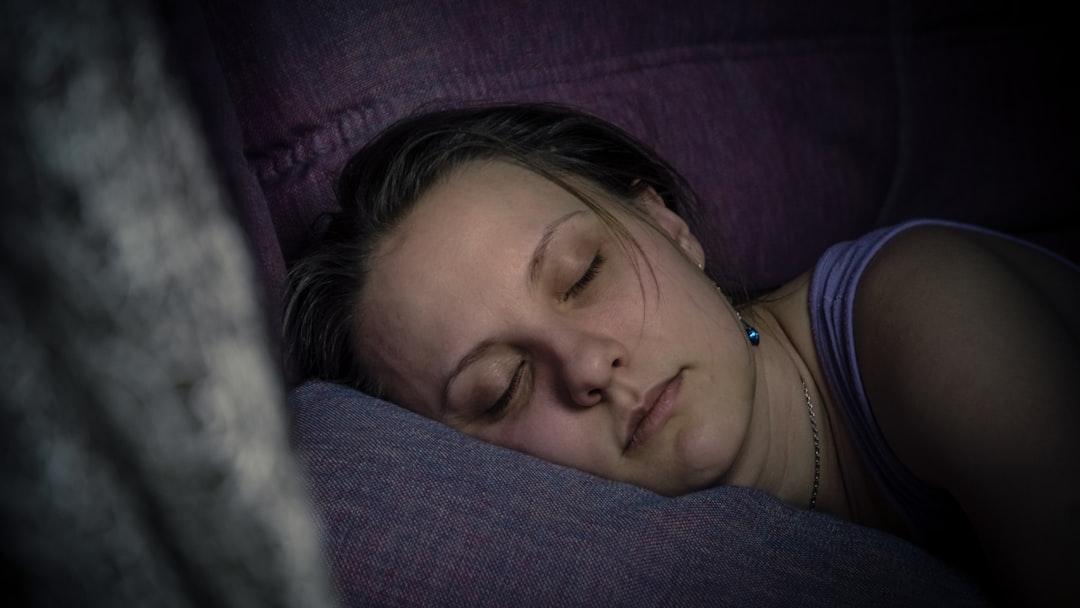 Beautiful young woman sleeping on the lilac sofa. Tired person after work. More of my photos and videos Adobe Stock:http://bit.ly/3RqlciK More of my photos and videos Shutterstock: https://www.shutterstock.com/g/ALEKSANDRBERDYUGIN My email: bermix999@gmail.com - Photo by Bermix Studio on Unsplash