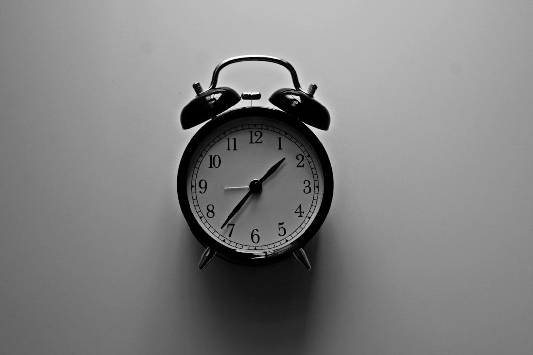 white bell alarm clock with black frame - Photo by Amanda Jones on Unsplash