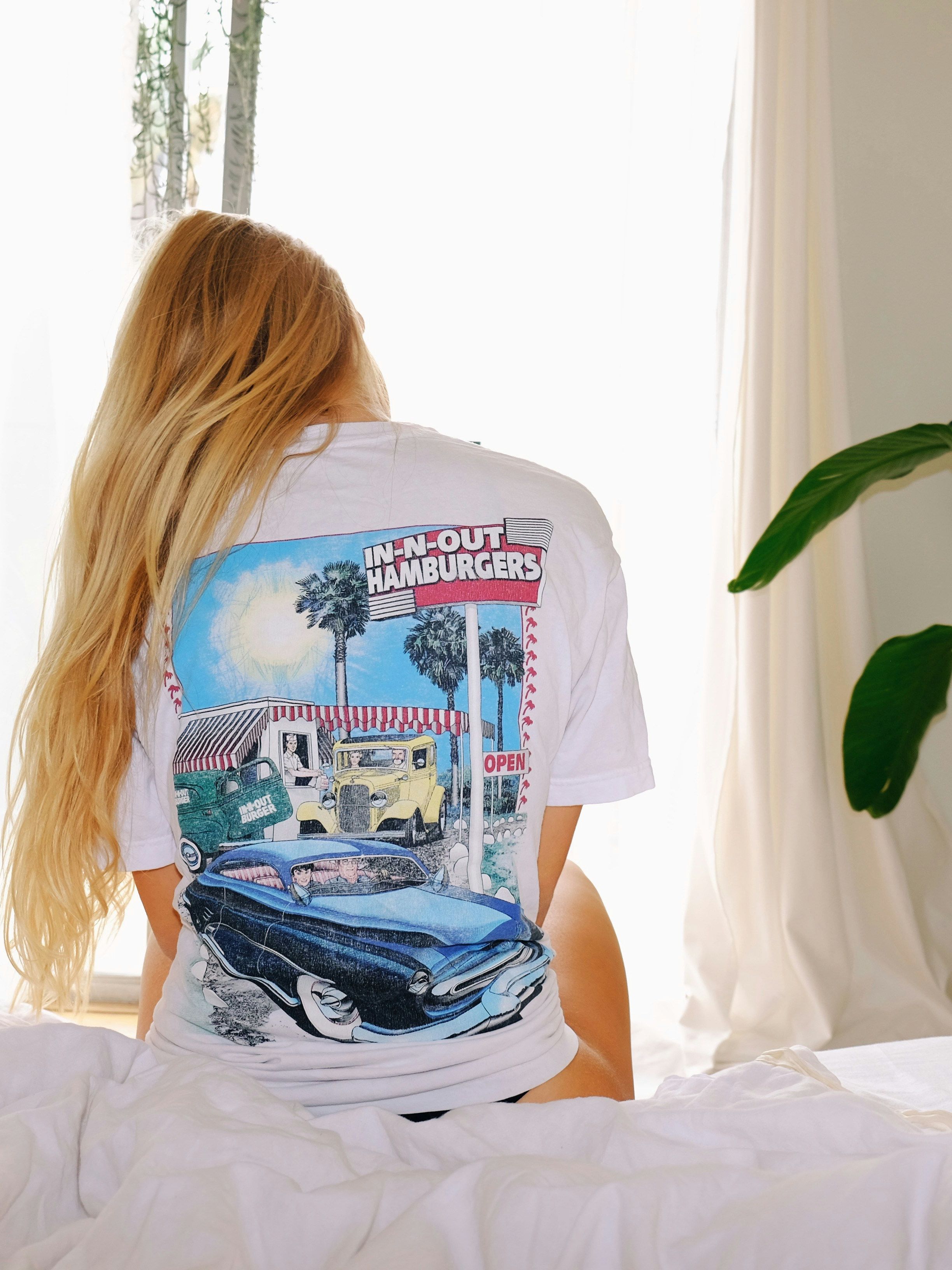 a woman waking up sittin on a ben