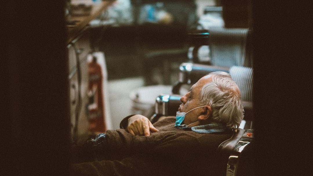 man in black long sleeve shirt lying on bed - Photo by Jon Tyson on Unsplash