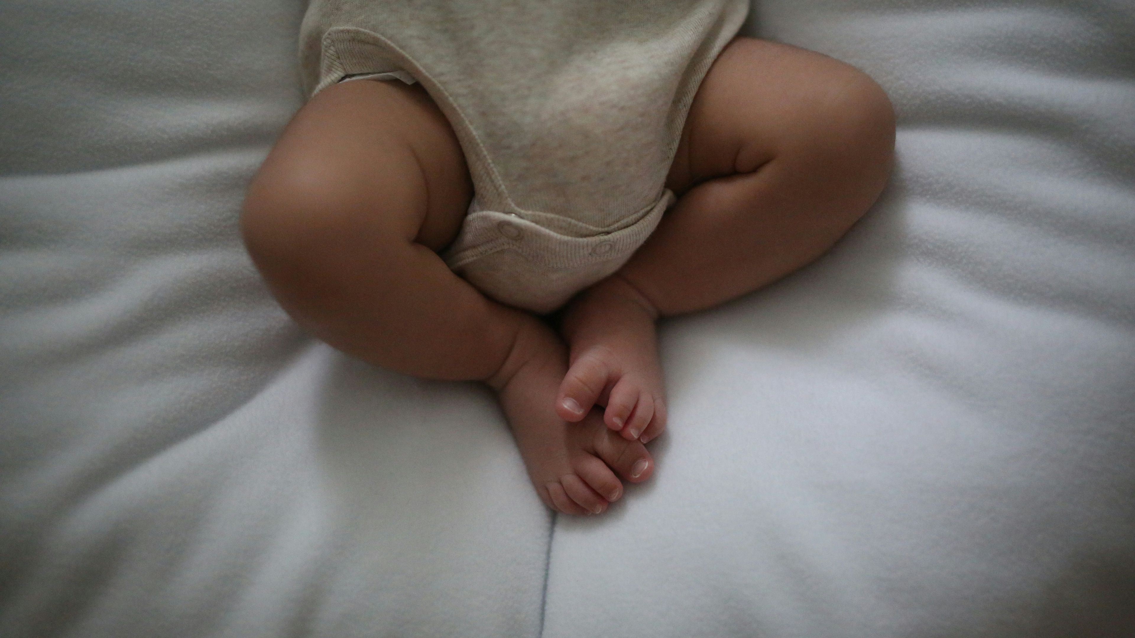 a baby is laying on a bed