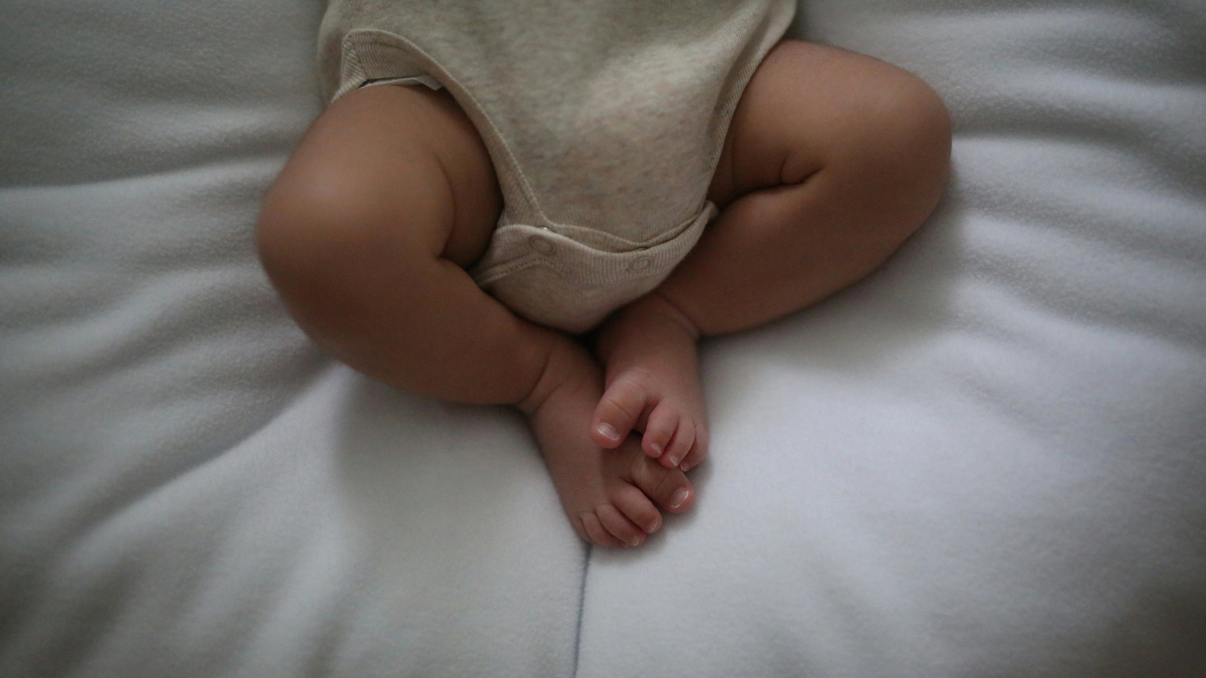 a baby is laying on a bed